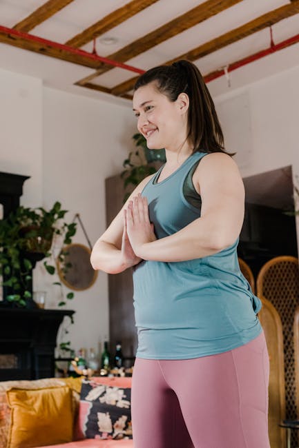 Woman performing a seated yoga pose in a well-lit room with house plants.